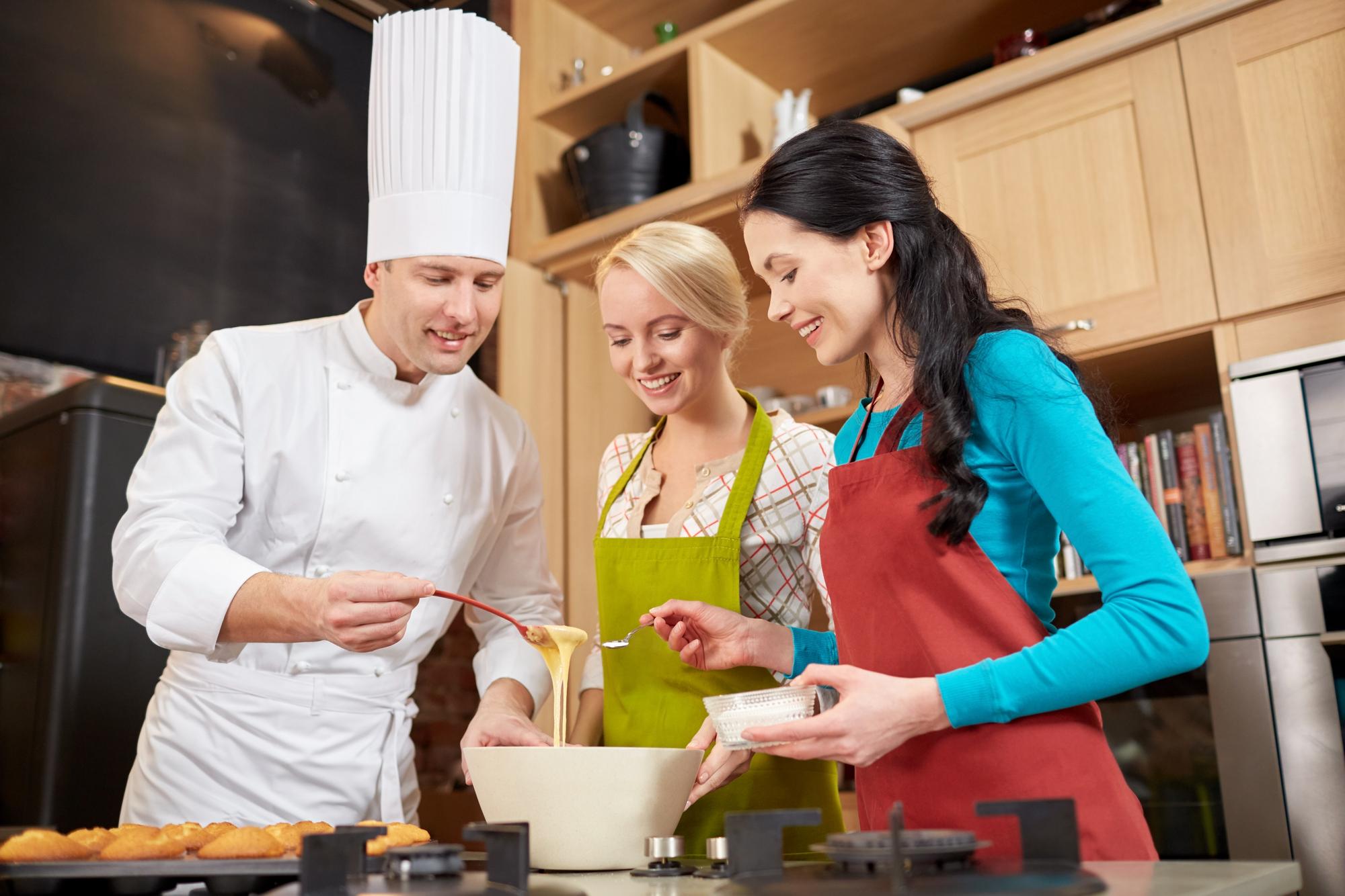 Small group cooking together in bright kitchen