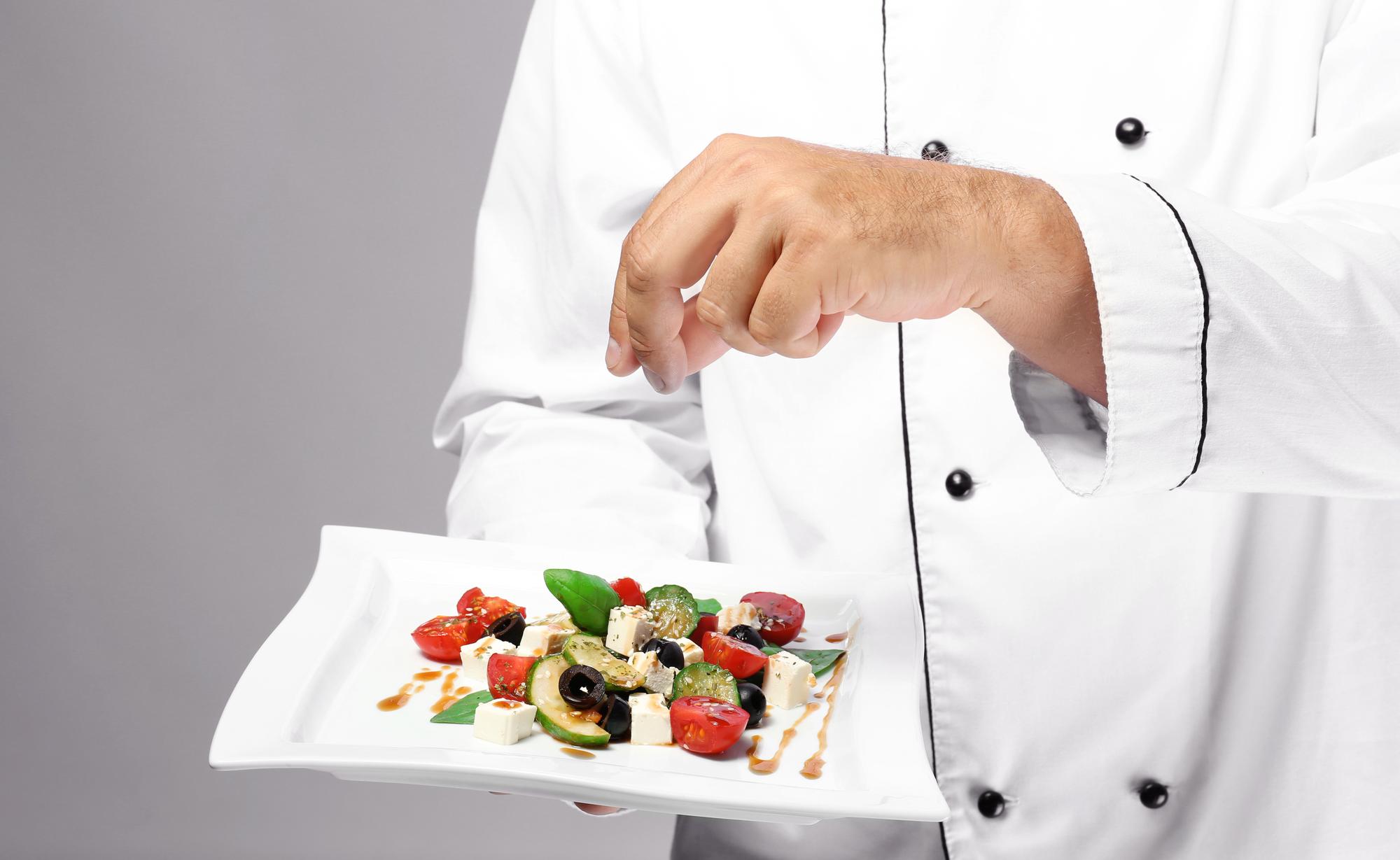 Chef demonstrating fast plating in workshop